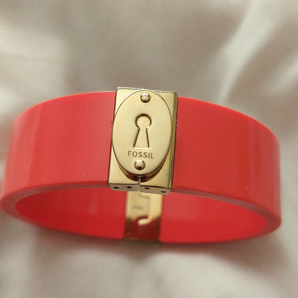 Fossil pinkish salmon colored hard plastic and gold tone bangle/cuff bracelet